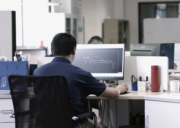 A worker is working in the front of a computer